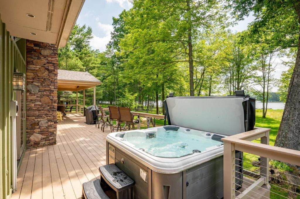 a jacuzzi tub on the deck of a house at Cottage On The Cove by Railey Vacations in Swanton