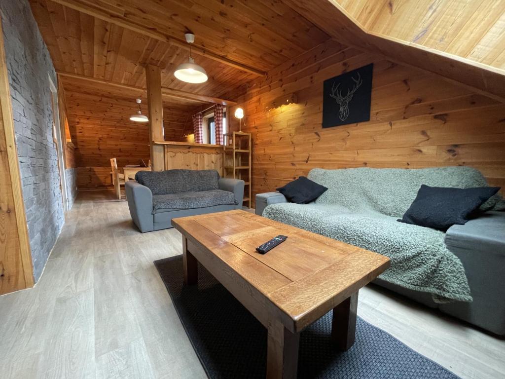 a living room with a couch and a coffee table at Appartement le bouc in Albepierre-Bredons