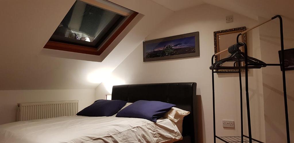 a bedroom with a bed with purple pillows on it at 5 Tamar in Findon