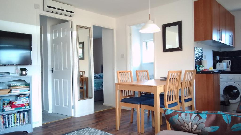 a kitchen and dining room with a table and chairs at The Nest in Hemsby