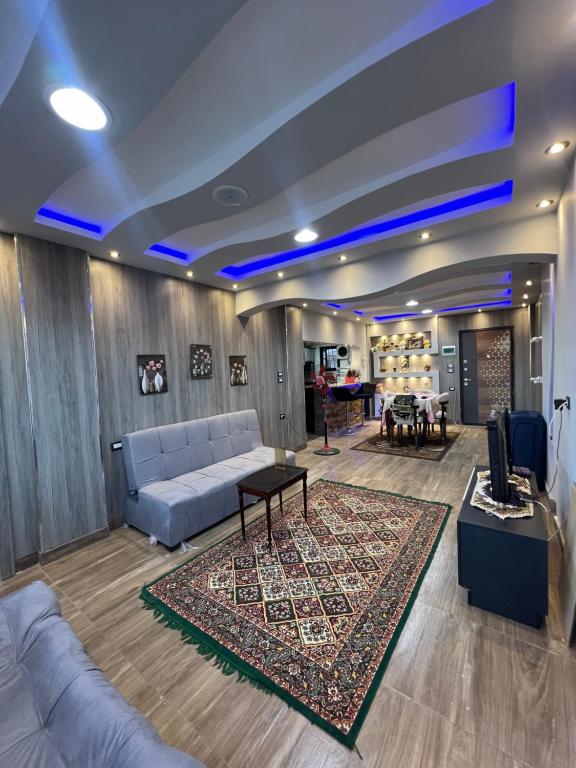 a living room with a couch and a table at Mazen Zakaria apartment in Port Said