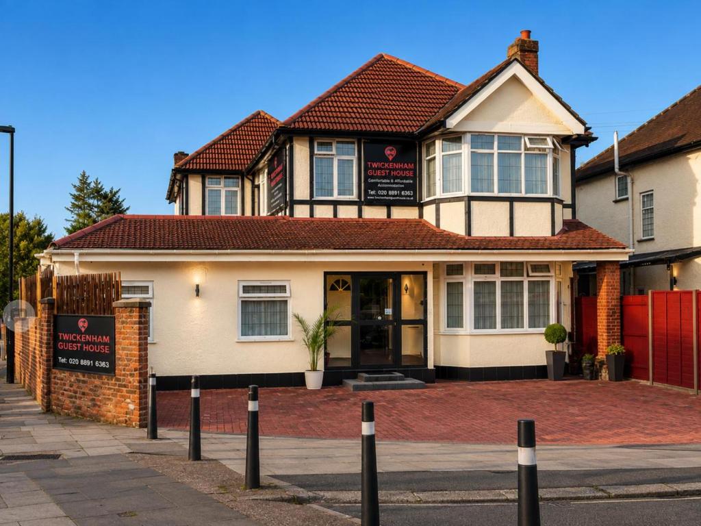 a house with a sign in front of it at Twickenham Guest House in Twickenham