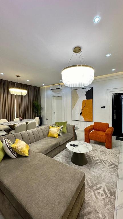 a living room with a couch and a table and chairs at Flat in lekki2 bed apartment in Lekki