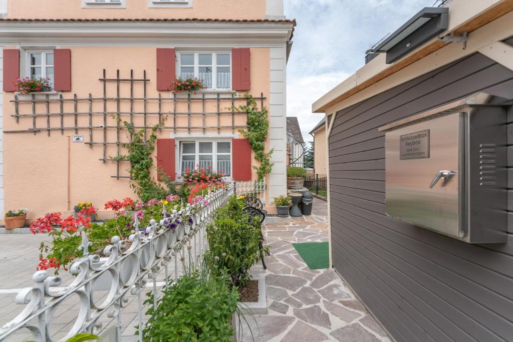 a fence with flowers in front of a building at A9 City Boardinghouse ,WiFi , Parking, VAT Invoice in Günzburg