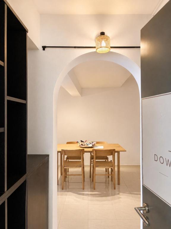 a dining room with a table and an archway at Downtown View Apartment - Rhodes in Rhodes Town