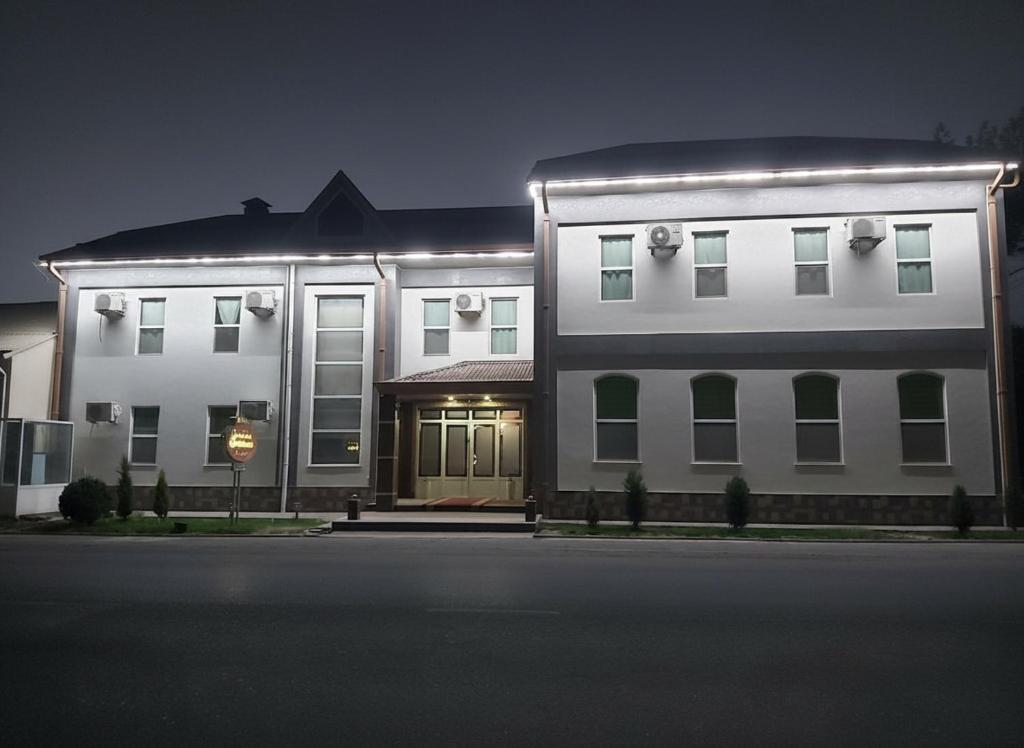 a large white building with lights on it at night at Comfort Continent in Oktyabrʼ