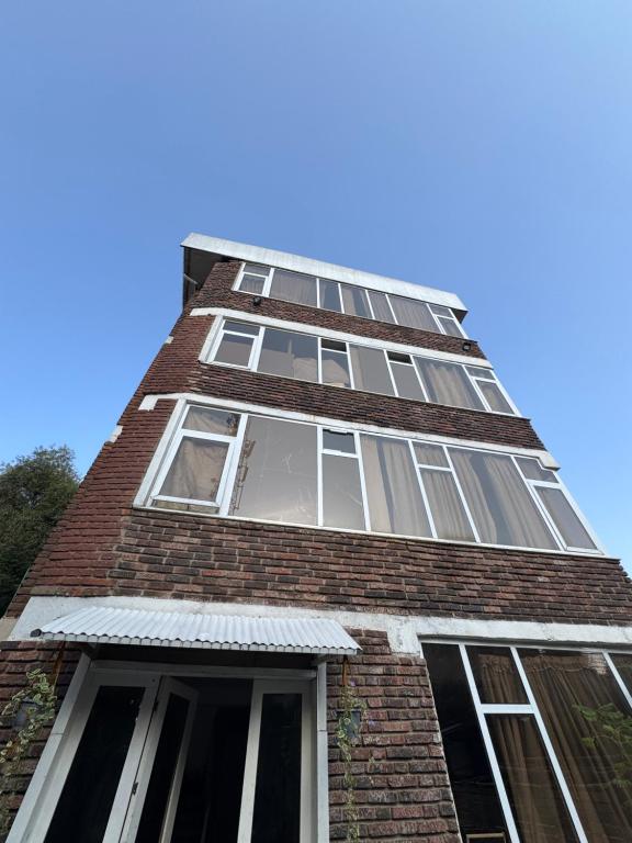 a tall brick building with windows on it at Casablanco Addis in Addis Ababa