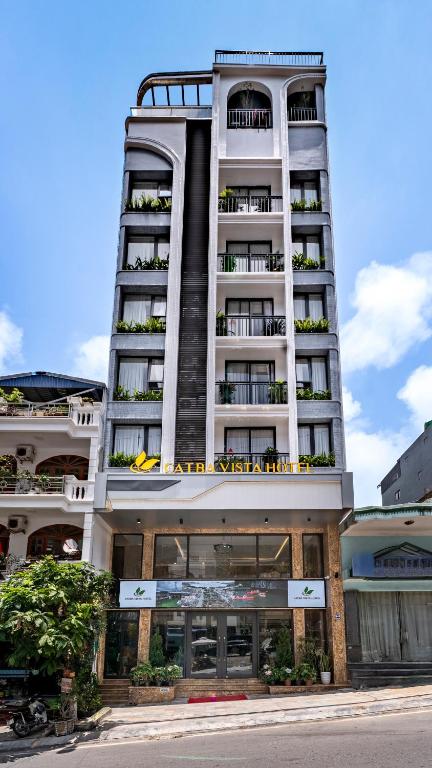 a tall white building with balconies on it at Cat Ba Vista Luxury Hotel - New 2026 - Rooftop Infinity Pool in Cat Ba