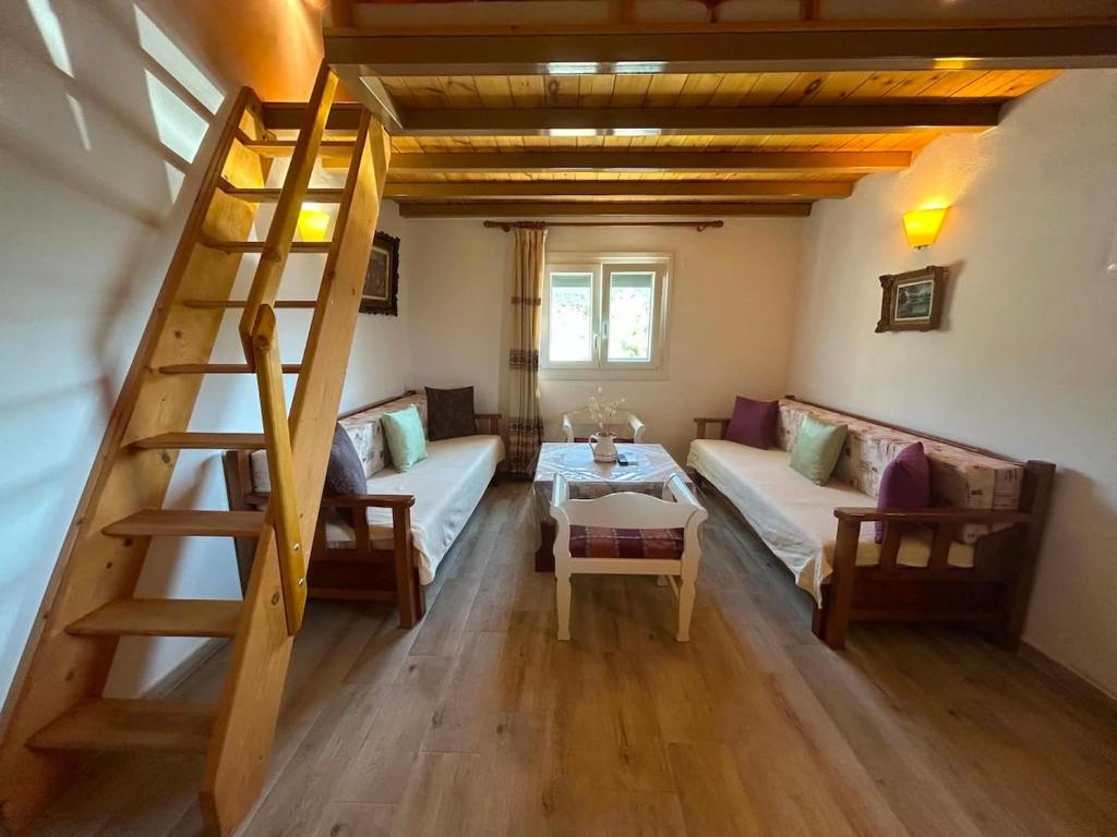 a living room with a staircase and a couch at Elia House in Skopelos Town