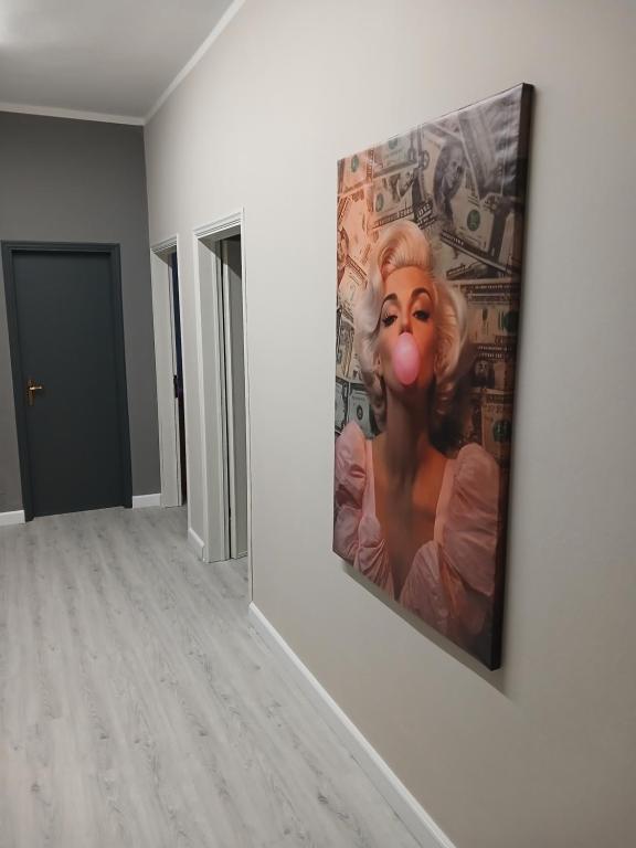 a painting of a woman with a red nose on a wall at B&B Angelo Azzurro in Carpi