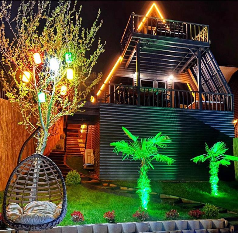 a house with palm trees and lights in the yard at Dilek Alagöz in Sapanca