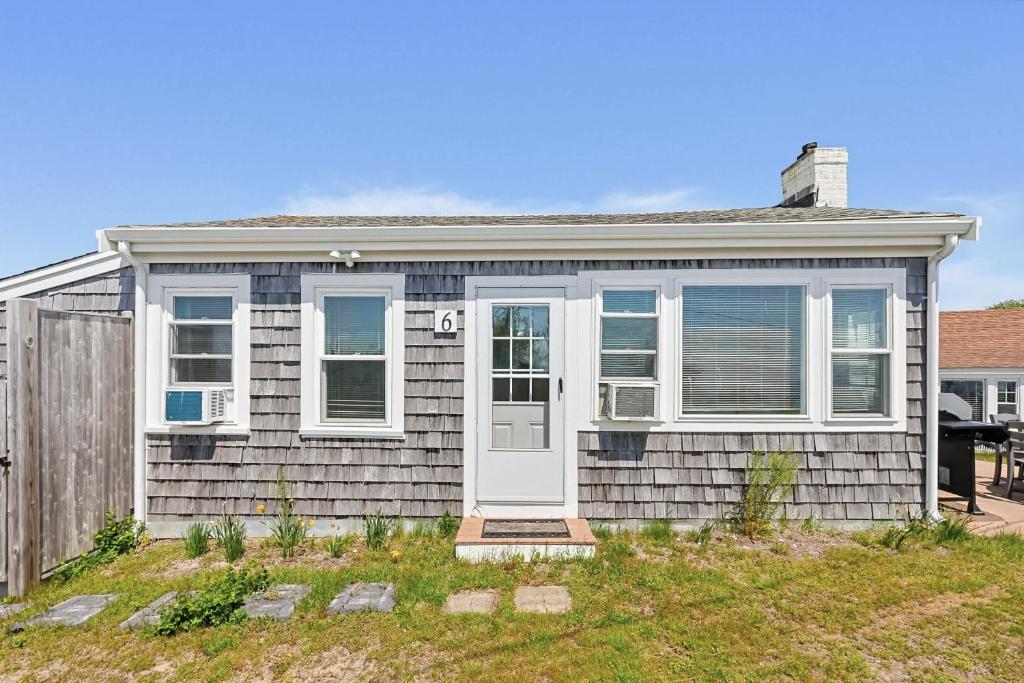 a house with a white door and a fence at Beach Home With Beautiful Ocean Views in Dennis