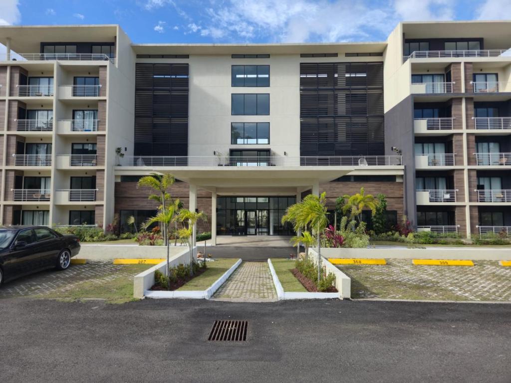 a building with a car parked in front of it at City View Luxe Condo in Mandeville