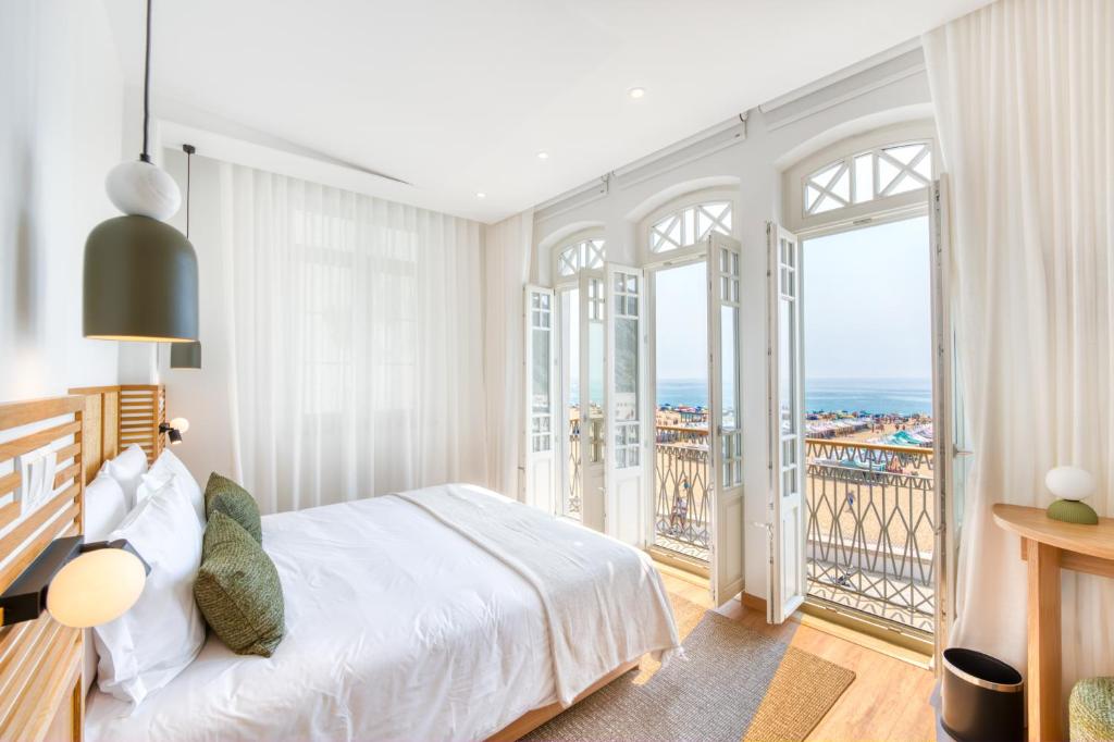 a bedroom with a bed and a balcony at Alluz Nazare - Boutique Chalet By The Sea in Nazaré