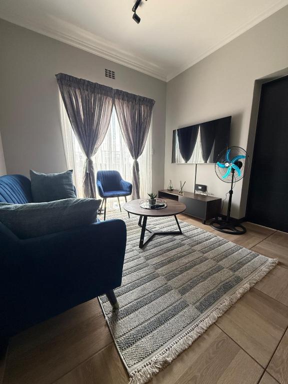 a living room with a couch and a table at The Precinct Lifestyle in Midrand