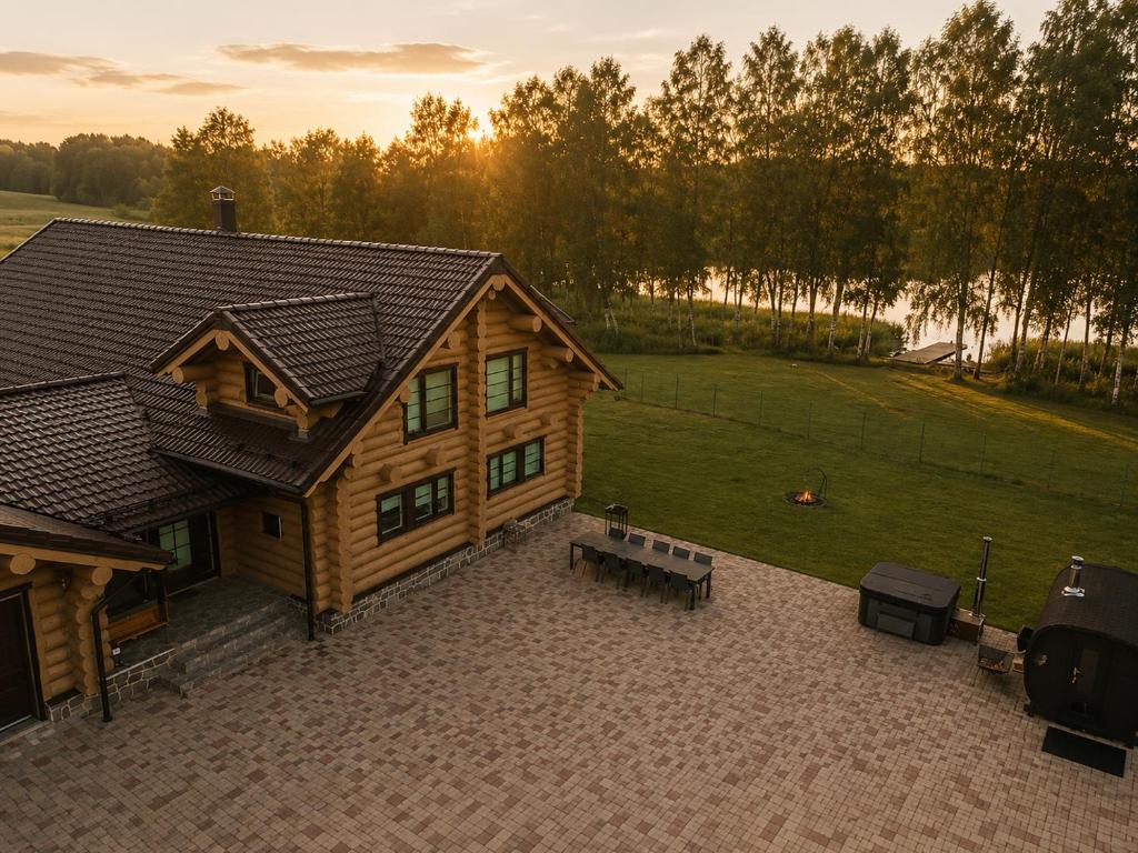 an overhead view of a log cabin with a picnic table at Private lakeside holiday house with fireplace, sauna, hot tub - Ezernams Dzintars in Valdemārpils