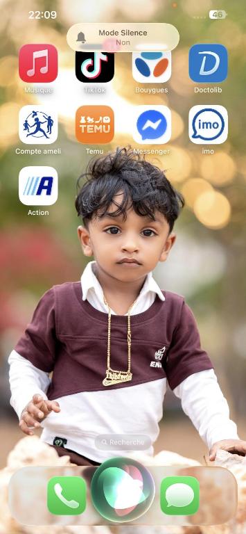 a young child is sitting on a table with various apps at Saro in Lourdes