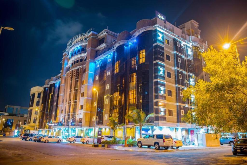 a large building with blue lights on top of it at Vercure Hotel فندق فيركيور جده الحمراء in Jeddah