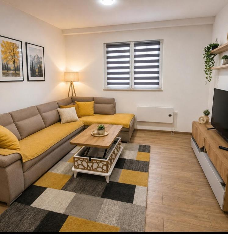 a living room with a couch and a coffee table at Apartman Trifko in Pale