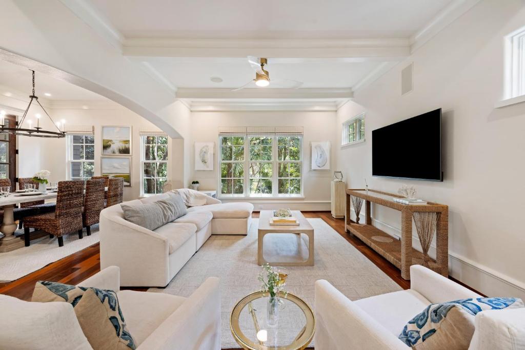 a living room with white furniture and a tv at 5556 Cypress Point in Kiawah Island