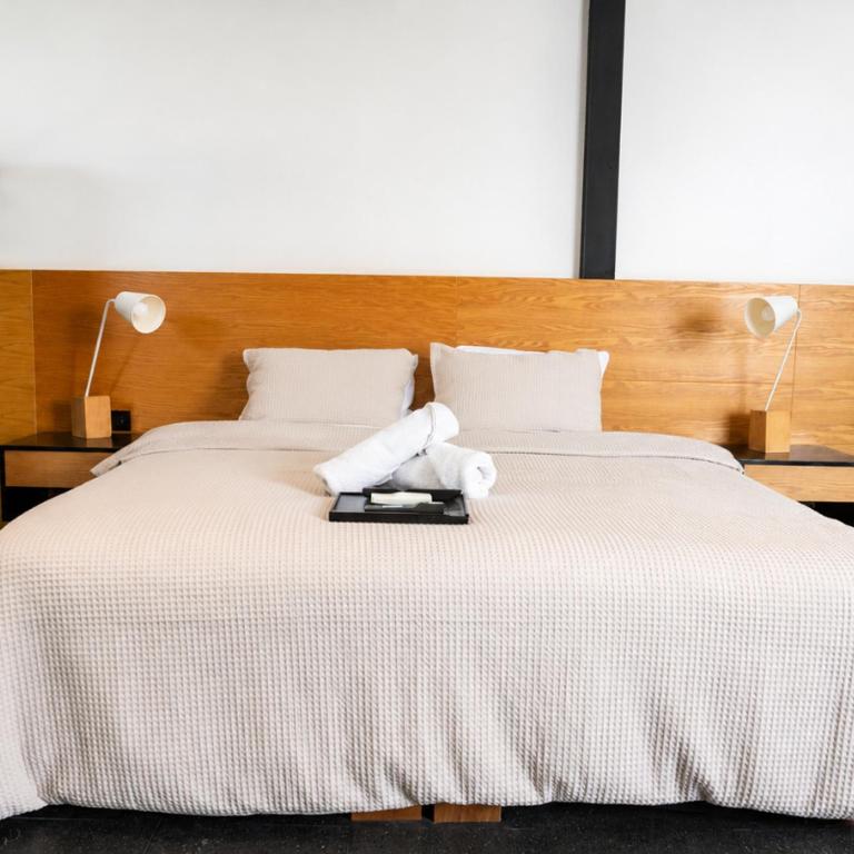 a bedroom with a large bed with a stuffed animal on it at Casa Caballero y Osio in Querétaro