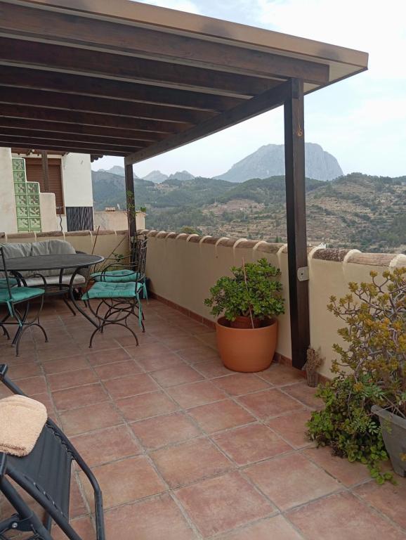 a patio with a table and chairs and a view at Casaroc in Sella