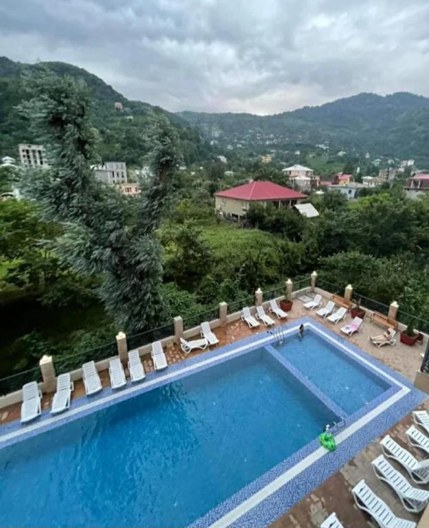 a swimming pool with a view of a resort at Archil in Batumi International Airport