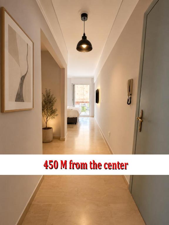 a room with a hallway with a door and a picture at Oli' Studio in Oropos