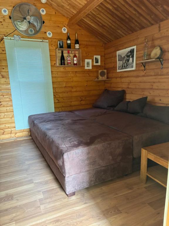 a bedroom with a large bed with a blue shutter at Naturunterkunft Leonberg in Leonberg