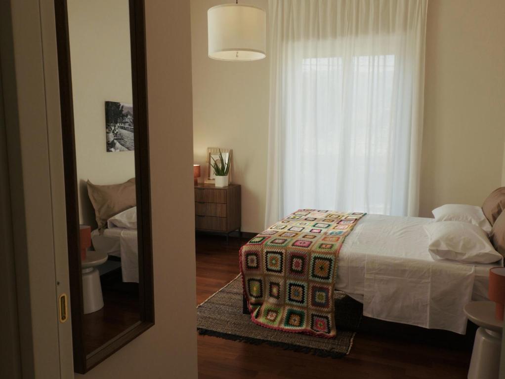 a bedroom with a bed and a window and a mirror at Domus Flumen in Alife