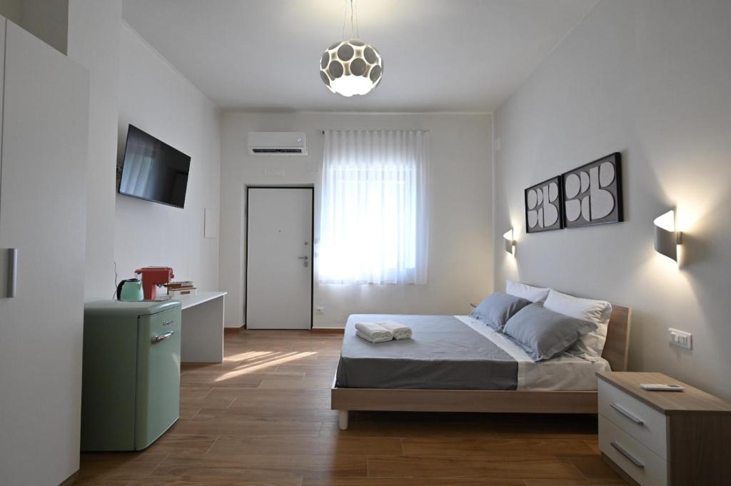 a bedroom with a bed and a desk and a window at Villa Grazia in Oliveto Citra
