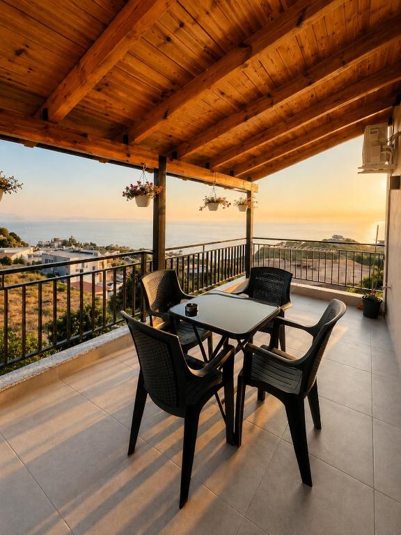 a patio with a table and chairs on a balcony at Villa Çela in Lukovë