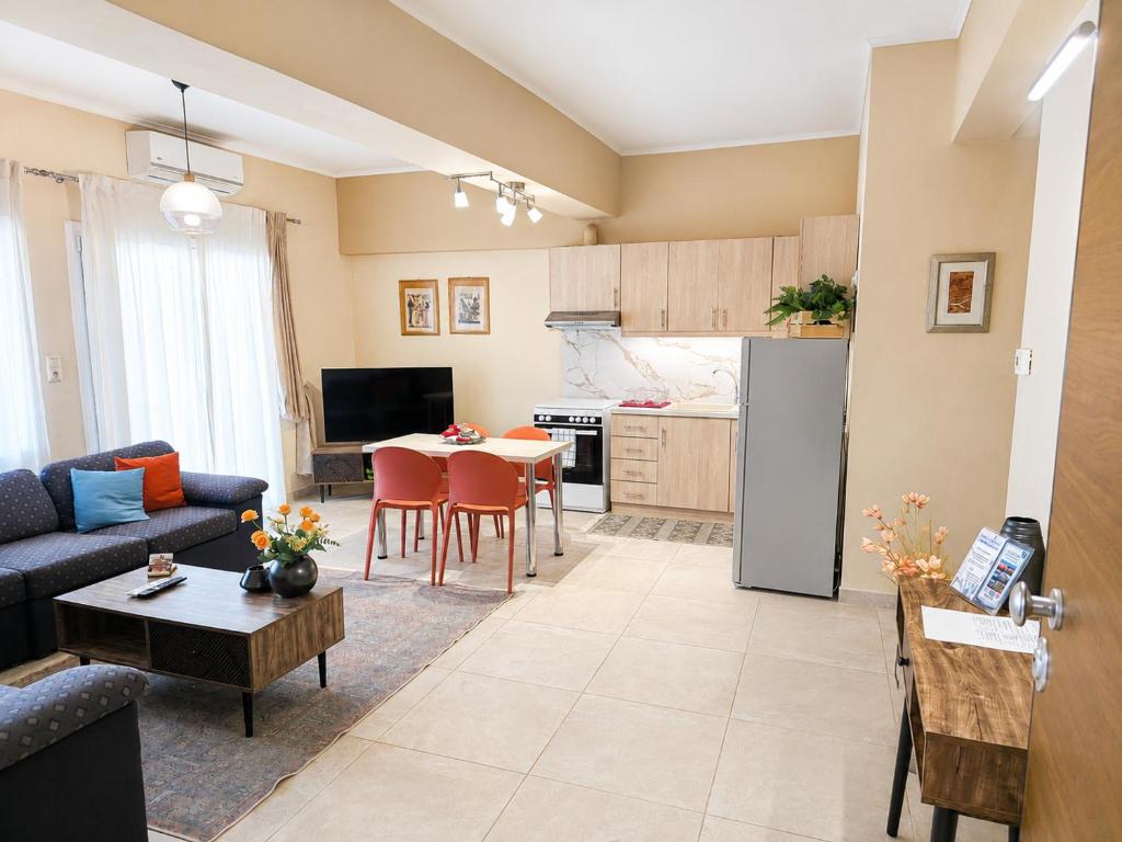 a living room with a couch and a table and a kitchen at Elena's nest in Kastoria