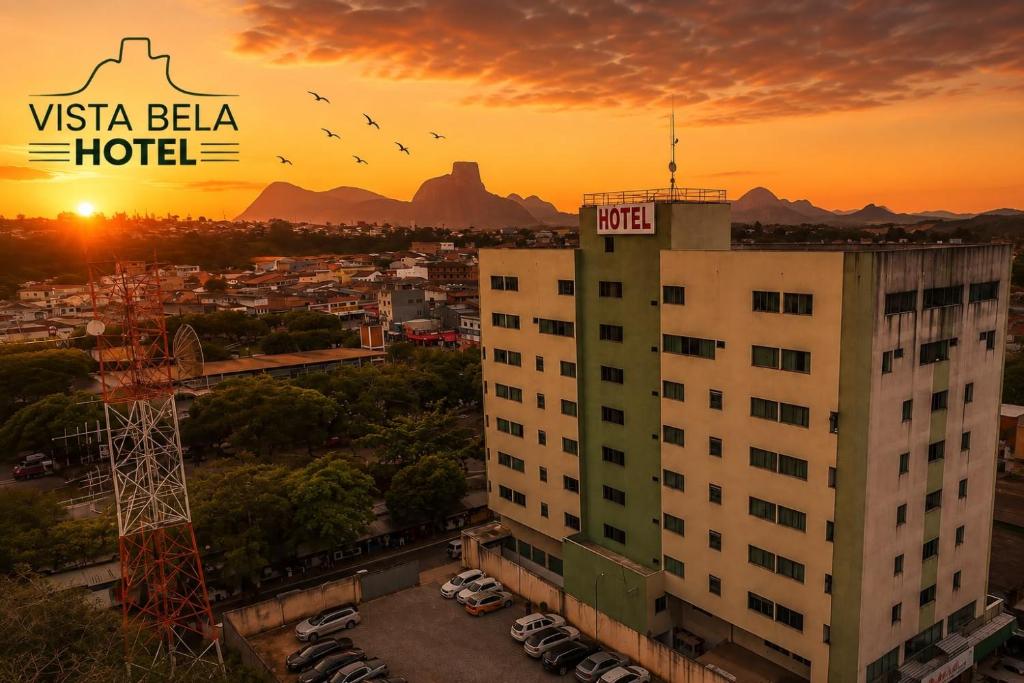a building with a hotel sign on top at sunset at Hotel Vista Bela in Itamaraju