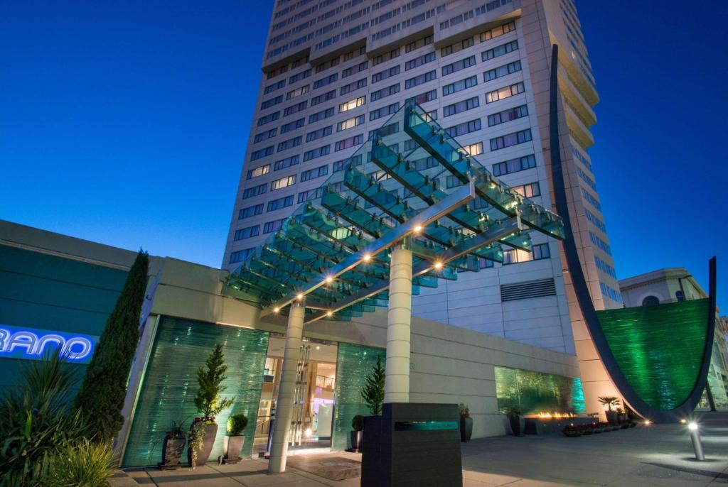 a tall building with a sign in front of it at Hotel Murano in Tacoma