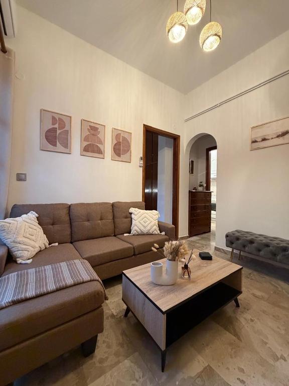 a living room with a couch and a coffee table at Petalidi seaside Retreat in Petalidi