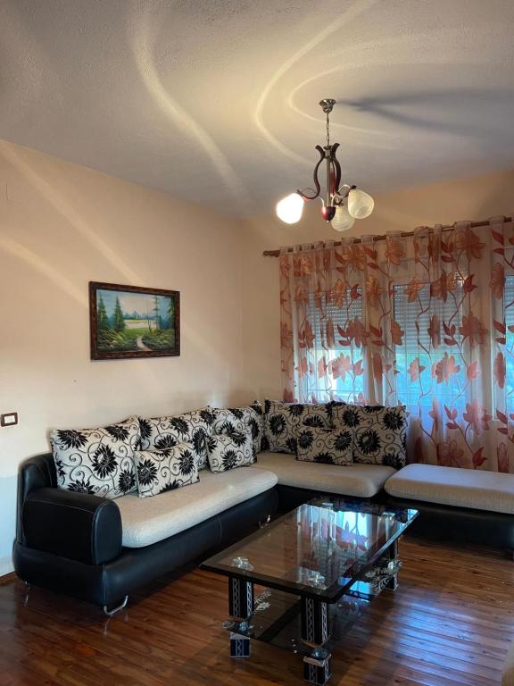 a living room with a couch and a coffee table at Family-friendly in Pogradec