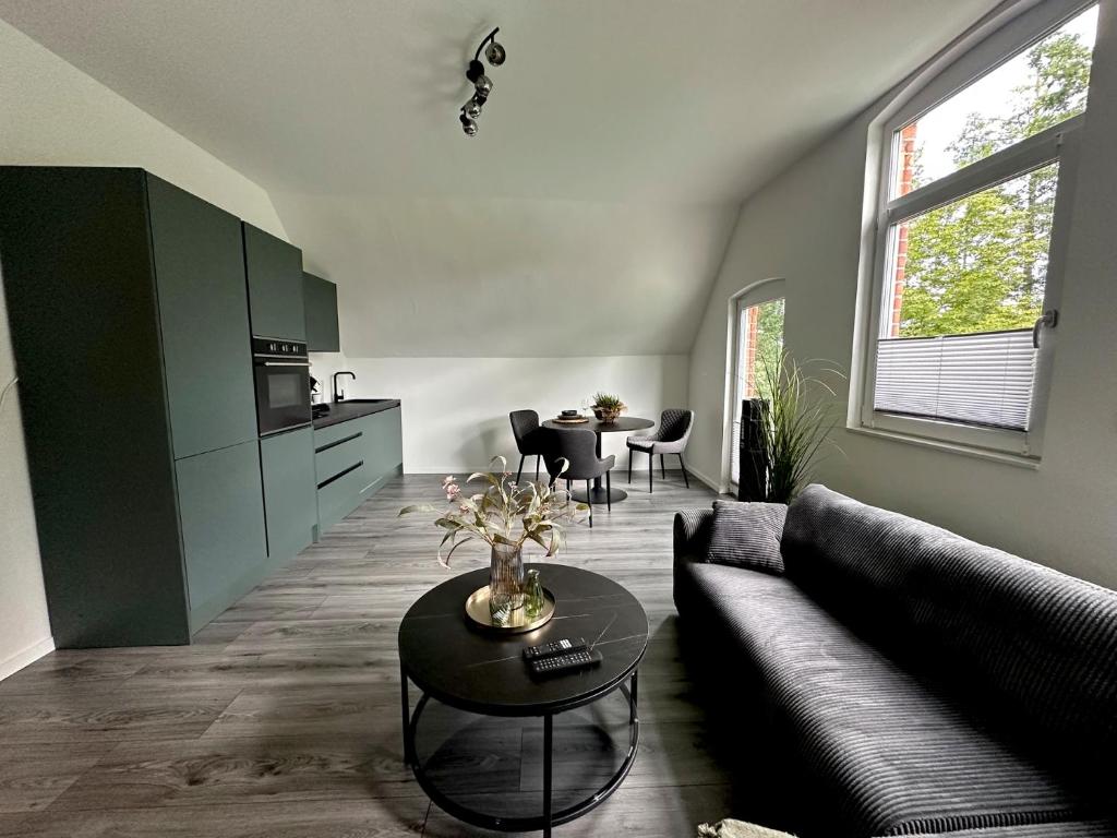 a living room with a couch and a table at Ferienwohnung Calluna in Faßberg