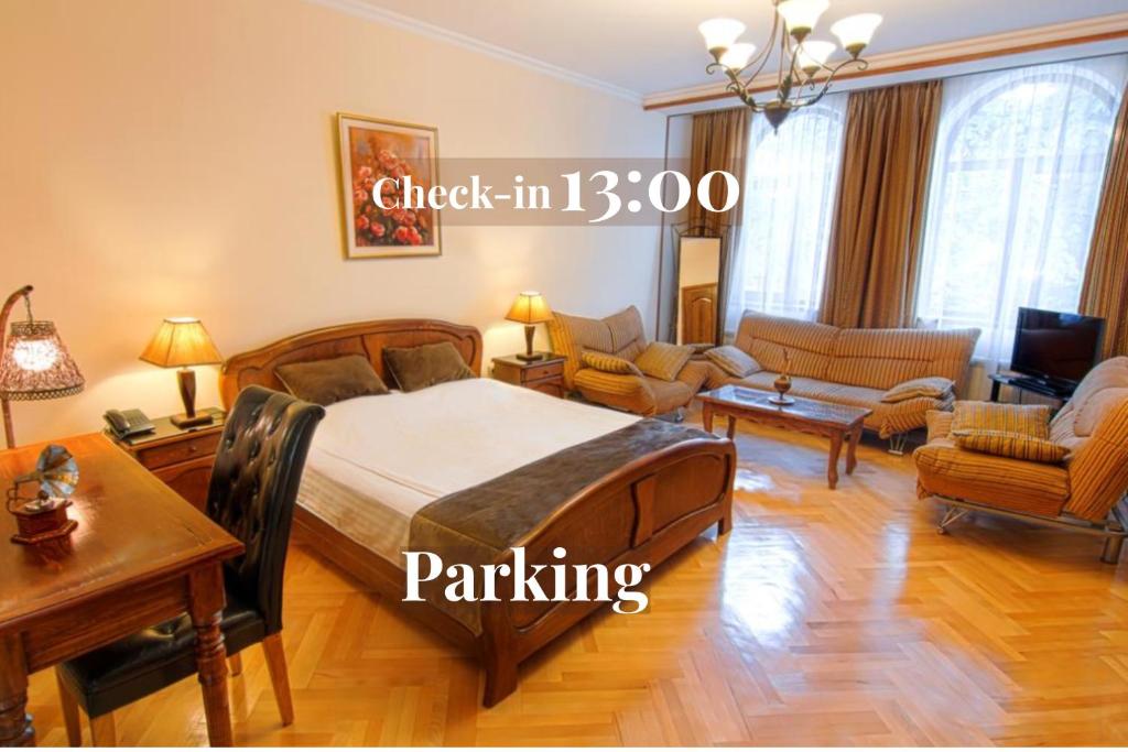 a bedroom with a bed and a living room at Hotel British House in Tbilisi City