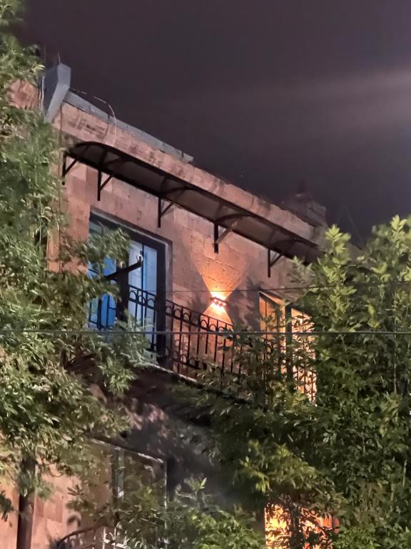 a building with a balcony at night at City Center in Vanadzor
