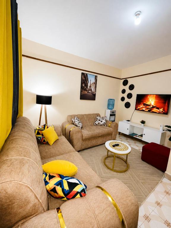 a living room with a couch and a fireplace at Nyeri 1 Bedroom BnB in Nyeri