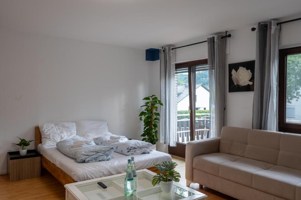 a living room with a couch and a coffee table at Restaurant Hotel Friesdorfer Hof in Bonn