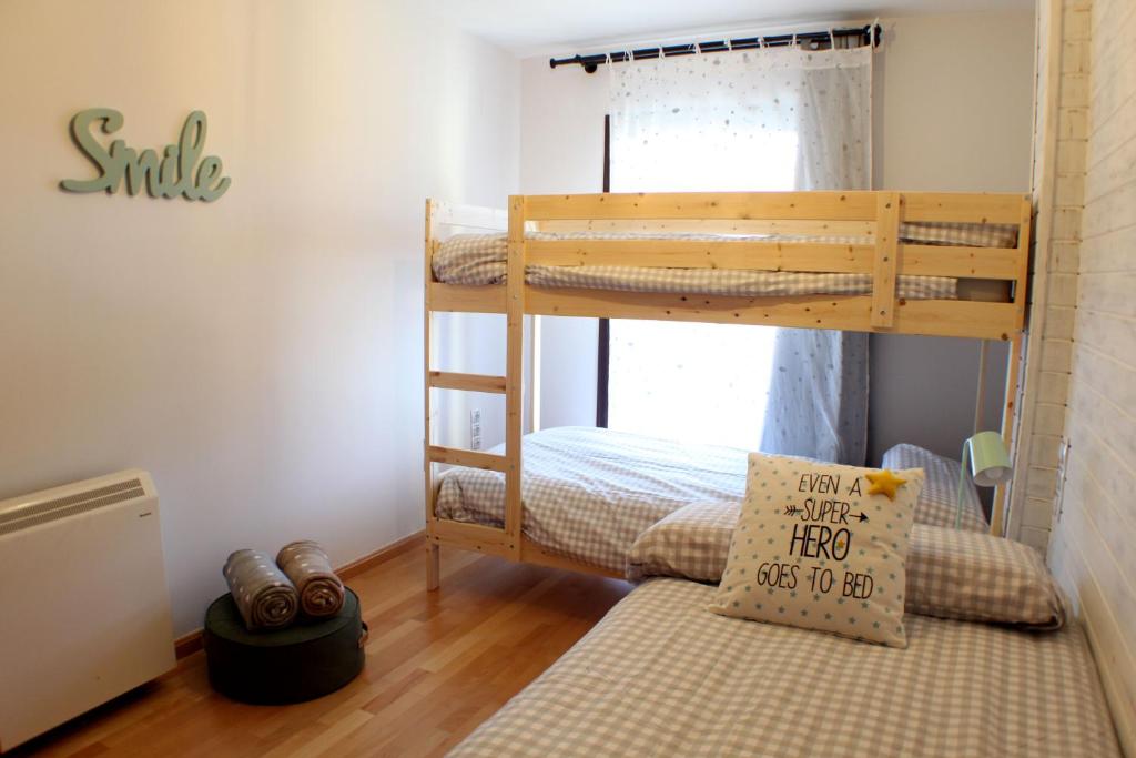 a bedroom with two bunk beds and a bed at Apartamento Alfa con parking y wifi by SURYNIEVE in Sierra Nevada