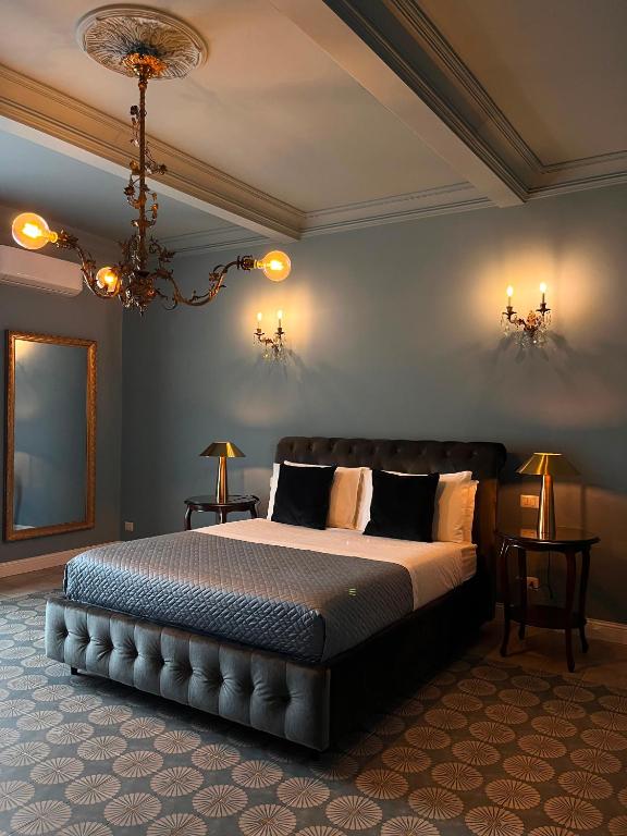 a bedroom with a large bed in a room at B&B Dàmur in Piazza Armerina