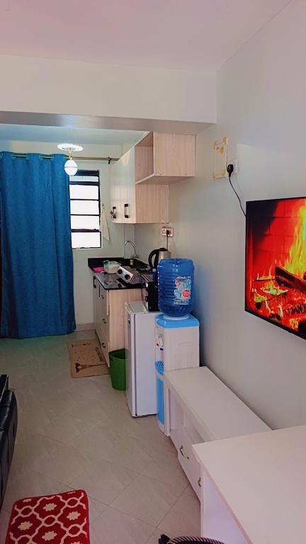 a kitchen with a painting on the wall at Amaziah apartment Mimyhomes in Nairobi