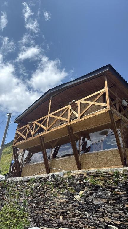 a wooden building on top of a stone wall at Guesthouse Mountain House in Khalde
