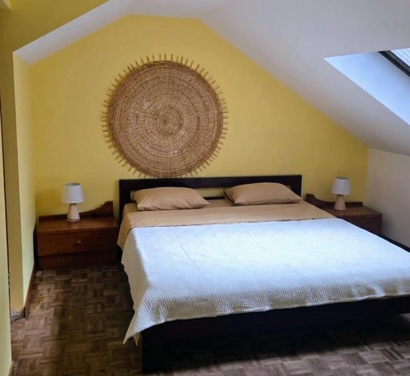 a bedroom with a bed with a largereath on the wall at Casa TIANA in Mindelo