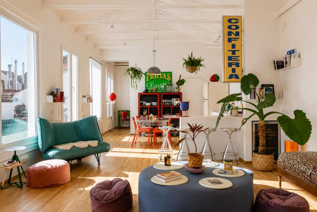 a living room with a couch and a table at Pop-Zen Penthouse Madrid in Madrid