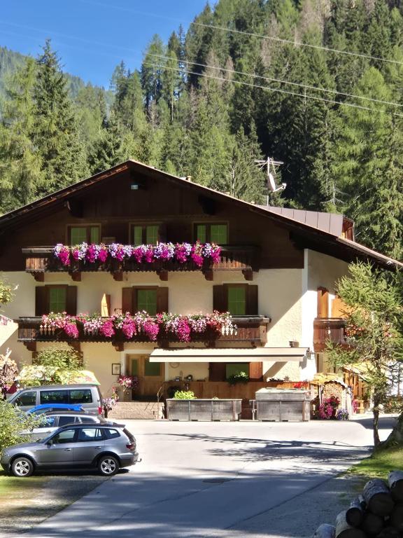 a car parked in front of a building with flowers at Bad Kalkstein in Innervillgraten