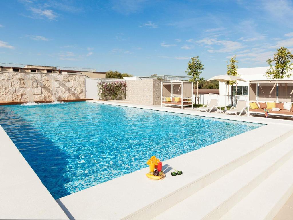 an image of a swimming pool at a villa at Aparthotel Adagio Rome Vatican in Rome